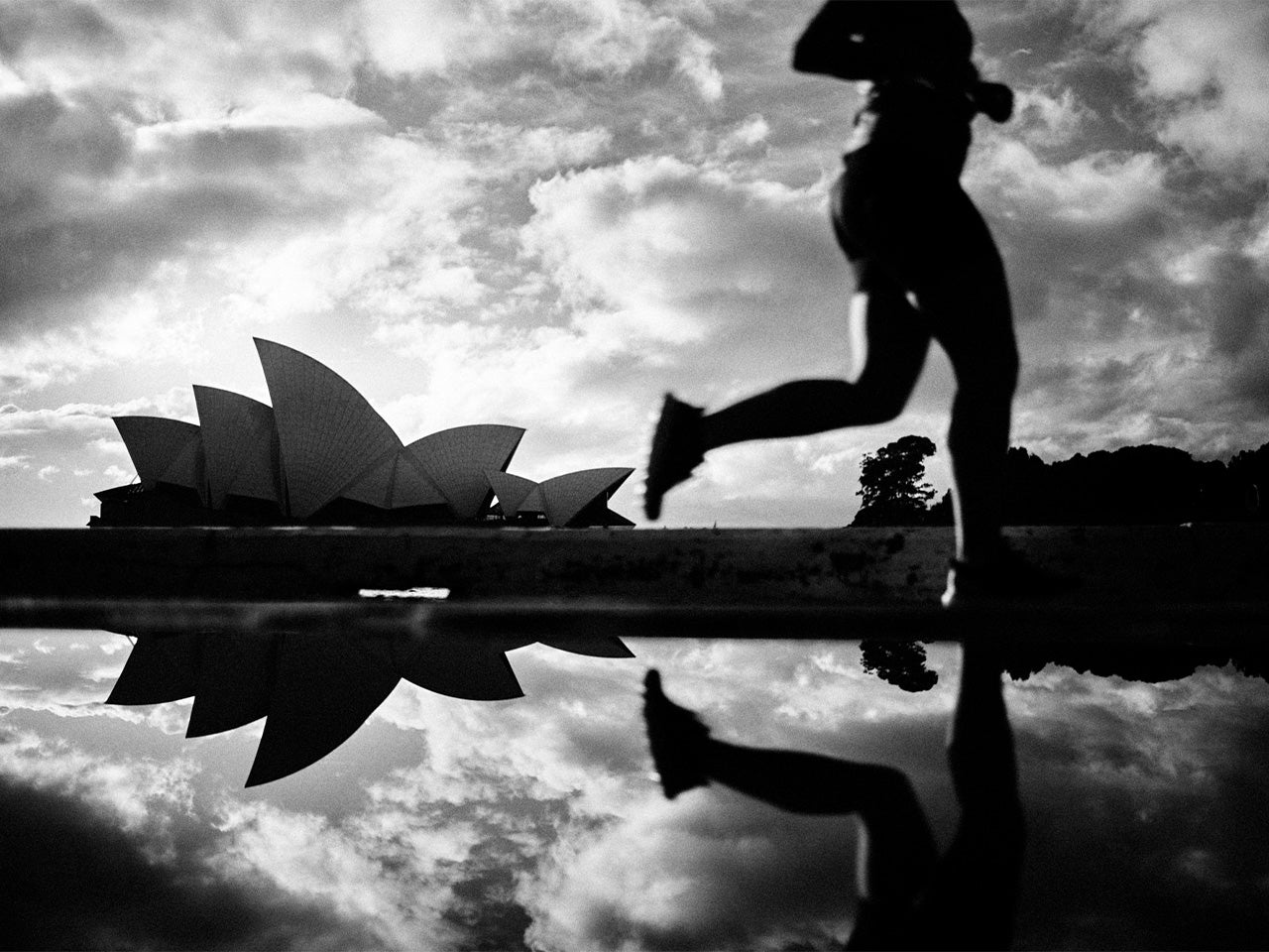 A runner running past the Sydney Opera House